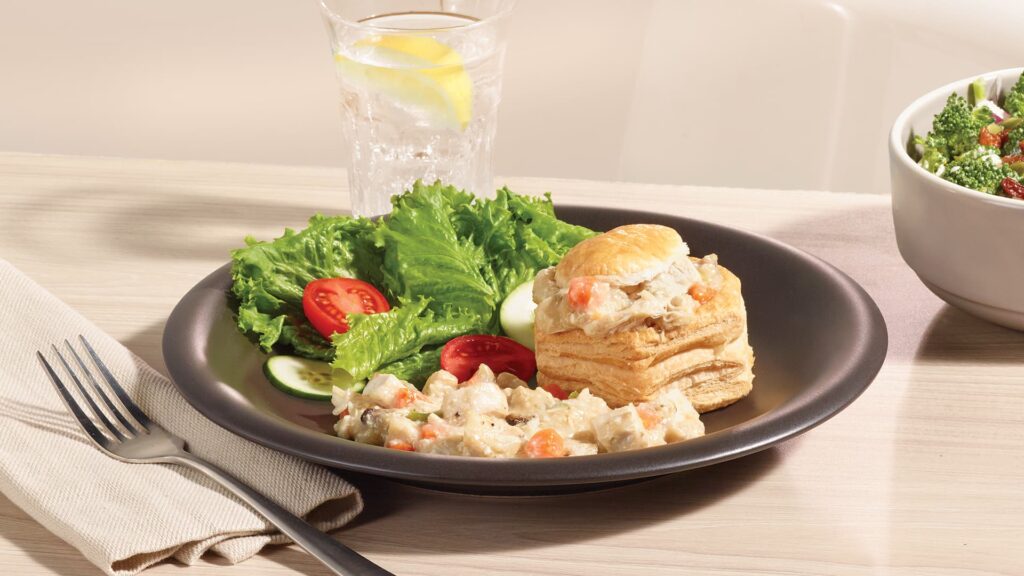 Ferme des Voltigeurs Grain-Fed Chicken Vol-au-Vent Filling served in a pastry shell, presented on a plate with salad.