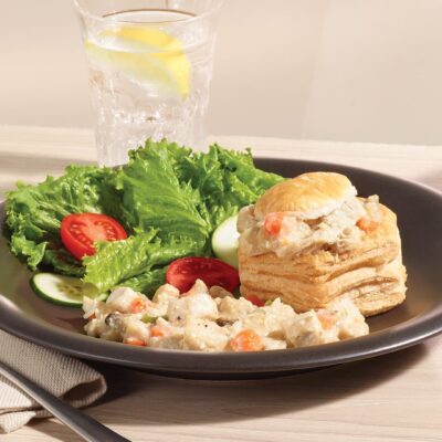 Ferme des Voltigeurs Grain-Fed Chicken Vol-au-Vent Filling served in a pastry shell, presented on a plate with salad.