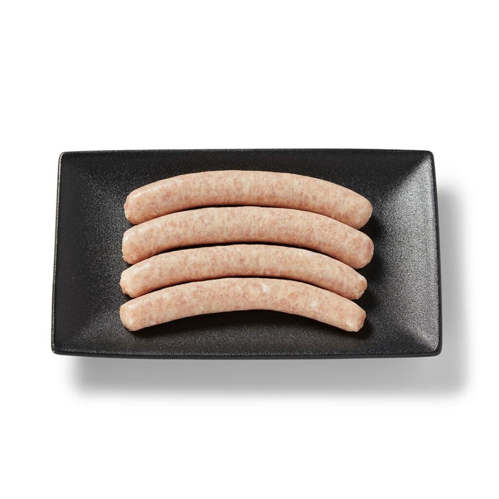 Saucisse de poulet dijonaise Ferme des Voltigeurs dans un plateau de présentation