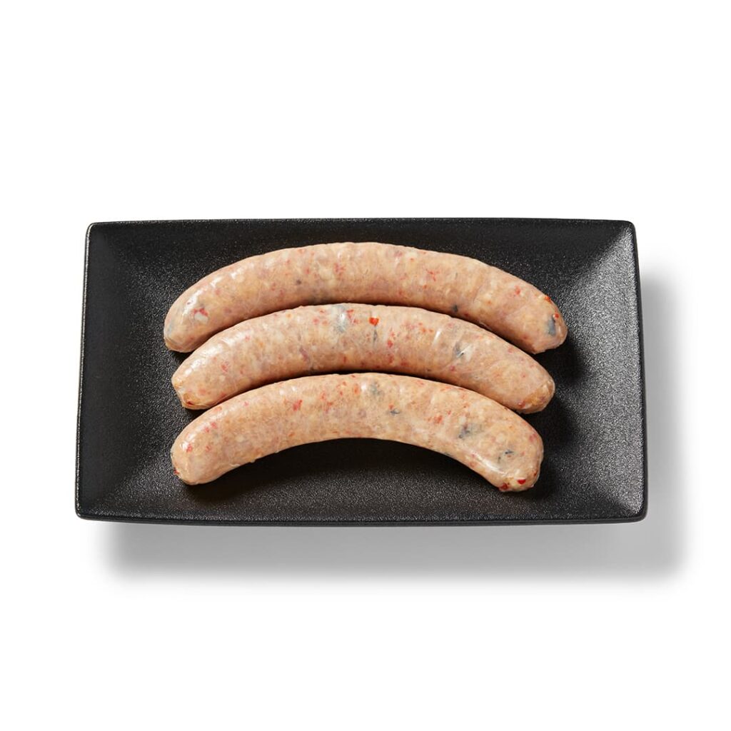 Saucisse de poulet méditerranéenne Ferme des Voltigeurs sur un plateau de présentation