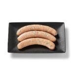 Saucisse de poulet méditerranéenne Ferme des Voltigeurs sur un plateau de présentation