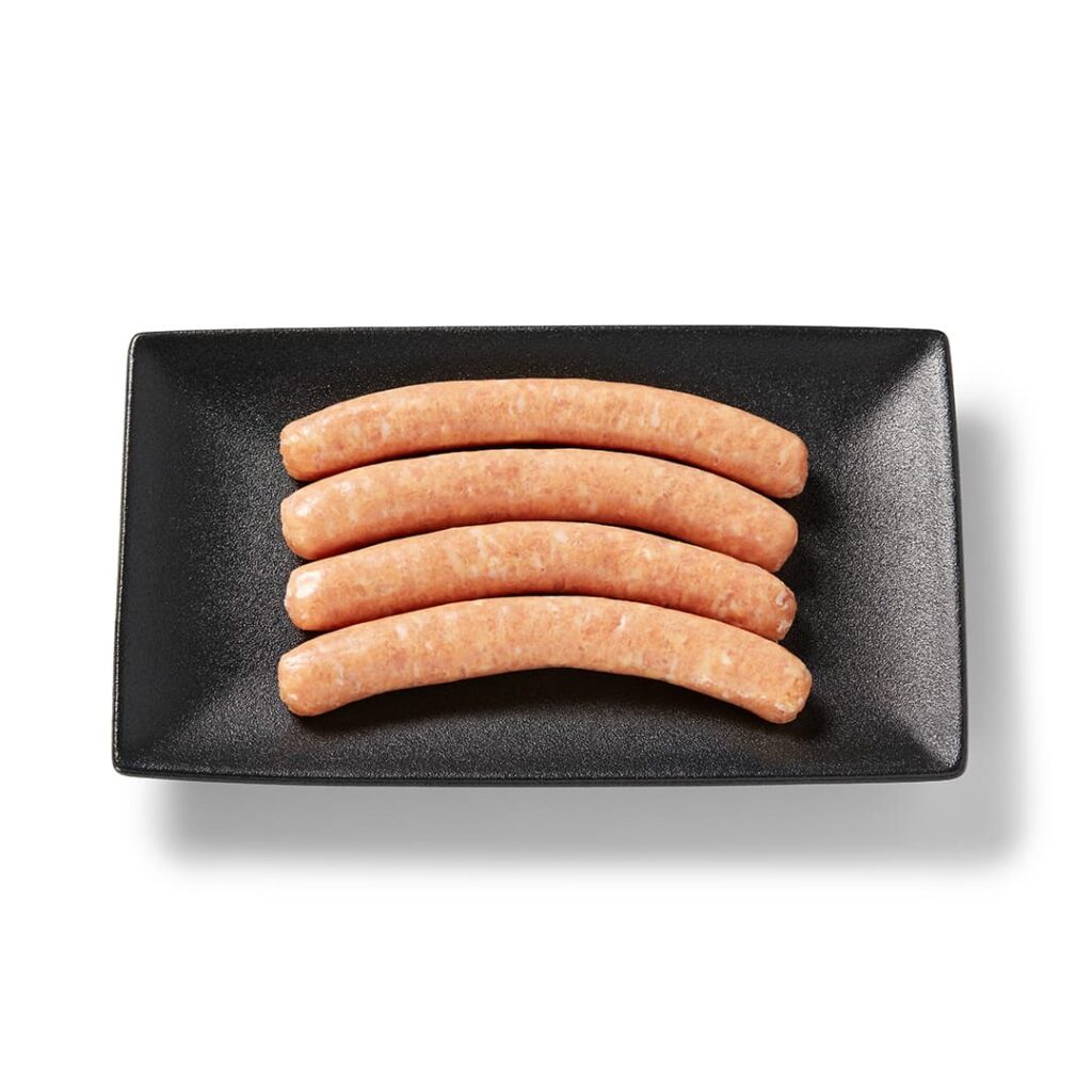 Saucisses de poulet regulière Ferme des Voltigeurs dans un plateau de présentation